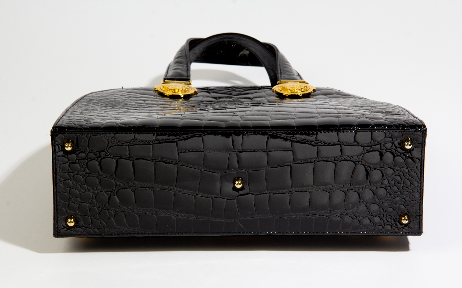 GIANNI VERSACE HANDBAG, black fabric with patent leather trims and top  handles, with top zip closure, lock and keys, bottom feet, iconic Medusa  logo at the front, black fabric lining, with dust